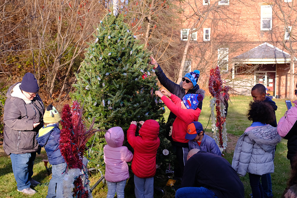 Parents and kids joined in by hanging ornaments on the tree.